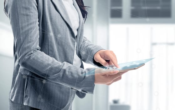 Business woman touch the digital tablet and display the interface of chart and graphs. Digital technology concept