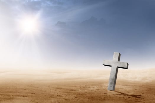 Christian cross on the desert with sun rays over dark sky background