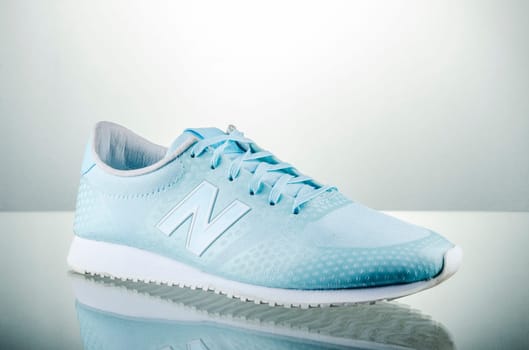 New Balance sports shoes isolated on gradient background