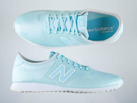 New Balance sports shoes isolated on gradient background