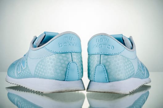 New Balance sports shoes isolated on gradient background