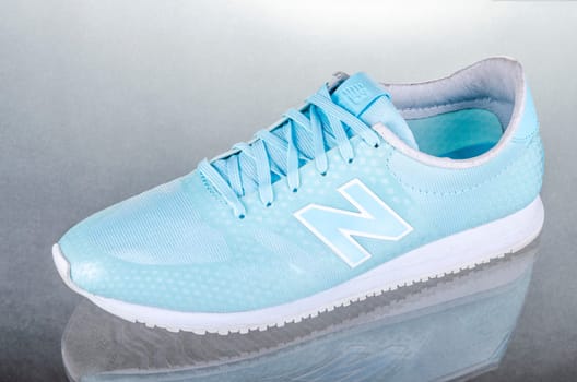New Balance sports shoes isolated on gradient background