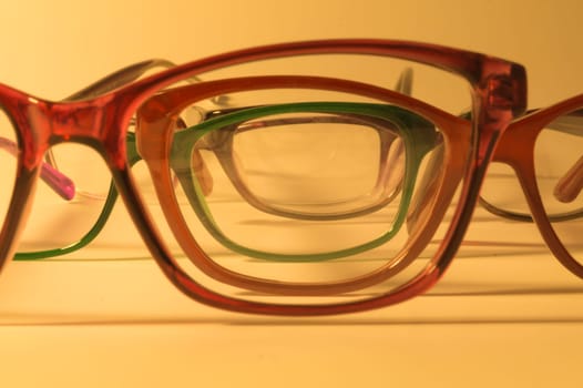 Rimmed eyeglasses closeup on a white background abstract view