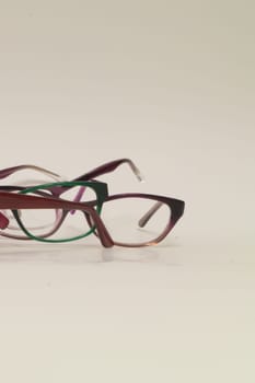 Rimmed eyeglasses closeup on a white background abstract view