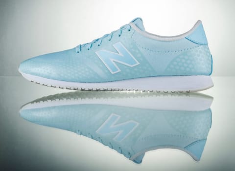 New Balance sports shoes isolated on gradient background