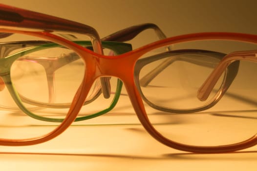 Rimmed eyeglasses closeup on a white background abstract view