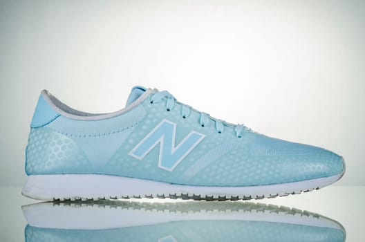New Balance sports shoes isolated on gradient background