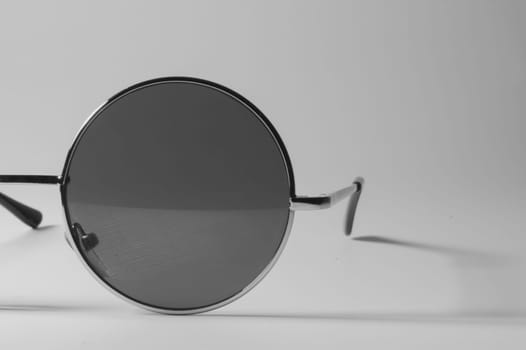Rimmed eyeglasses closeup on a white background abstract view