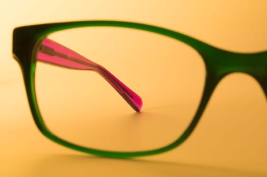 Rimmed eyeglasses closeup on a white background abstract view