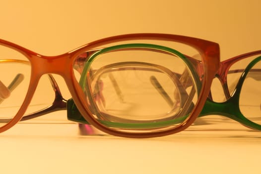 Rimmed eyeglasses closeup on a white background abstract view