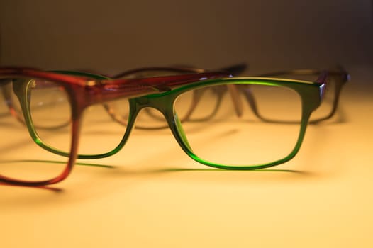 Rimmed eyeglasses closeup on a white background abstract view