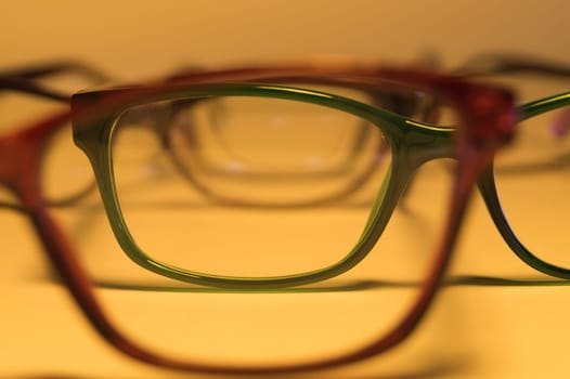 Rimmed eyeglasses closeup on a white background abstract view