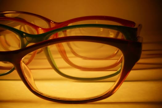 Rimmed eyeglasses closeup on a white background abstract view