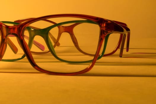 Rimmed eyeglasses closeup on a white background abstract view