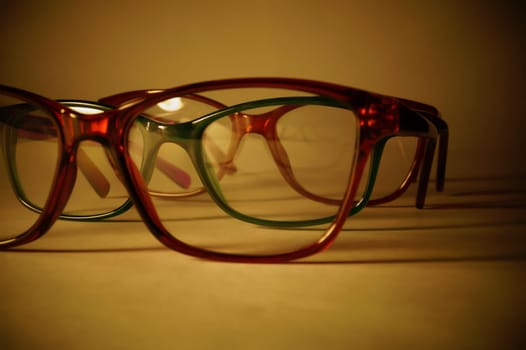 Rimmed eyeglasses closeup on a white background abstract view