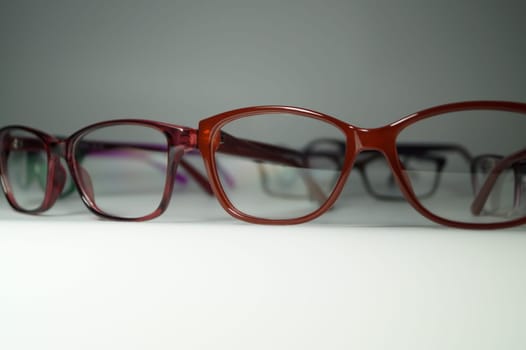 Rimmed eyeglasses closeup on a white background abstract view
