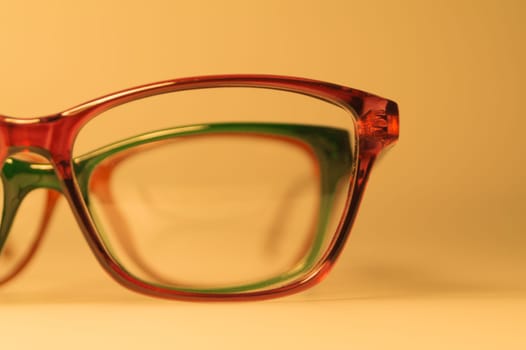 Rimmed eyeglasses closeup on a white background abstract view