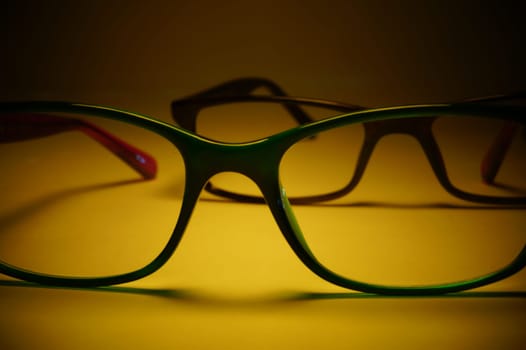 Rimmed eyeglasses closeup on a white background abstract view