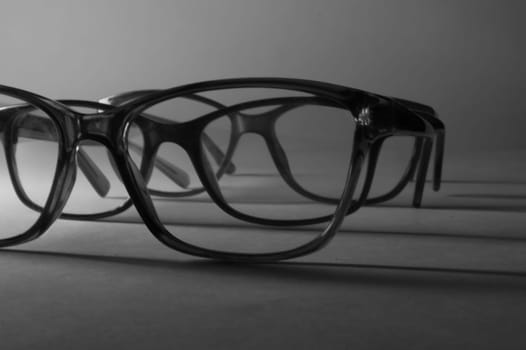 Rimmed eyeglasses closeup on a white background abstract view