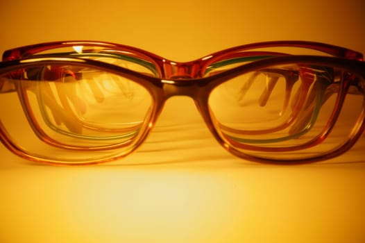 Rimmed eyeglasses closeup on a white background abstract view