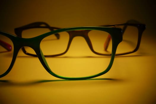 Rimmed eyeglasses closeup on a white background abstract view
