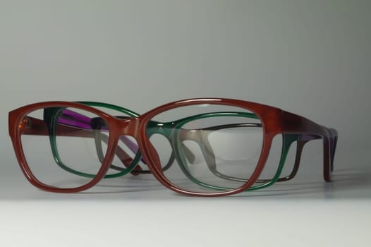 Rimmed eyeglasses closeup on a white background abstract view