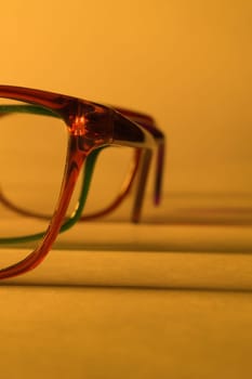 Rimmed eyeglasses closeup on a white background abstract view
