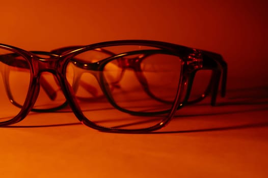 Rimmed eyeglasses closeup on a white background abstract view