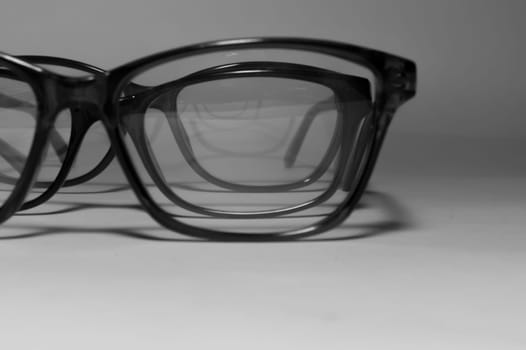 Rimmed eyeglasses closeup on a white background abstract view