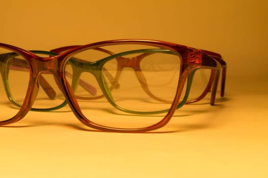 Rimmed eyeglasses closeup on a white background abstract view