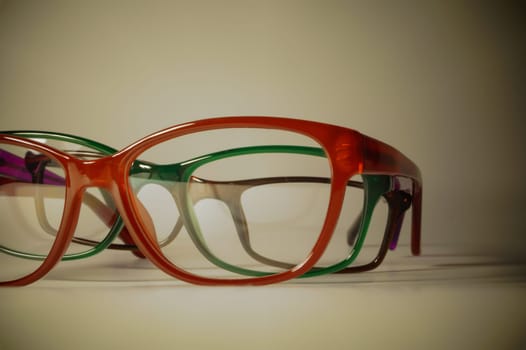 Rimmed eyeglasses closeup on a white background abstract view