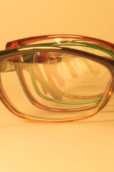 Rimmed eyeglasses closeup on a white background abstract view
