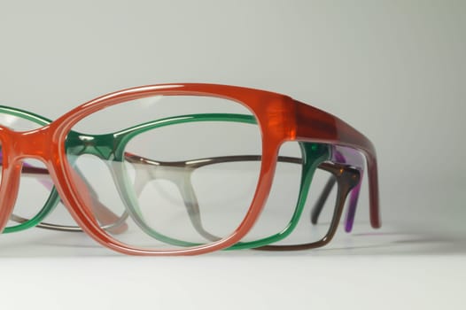 Rimmed eyeglasses closeup on a white background abstract view