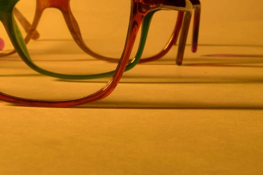 Rimmed eyeglasses closeup on a white background abstract view