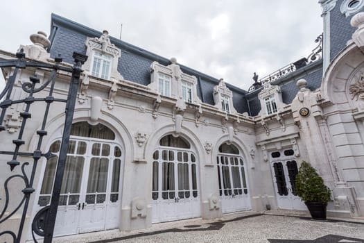 Detail of the wide doors and windows on the mansard roof of the horse stables of the Vale Flor Palace in Alcantara, Lisbon, Portugal