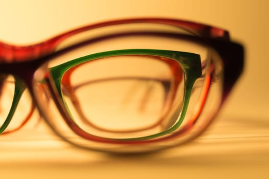Rimmed eyeglasses closeup on a white background abstract view