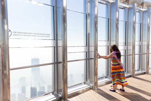 Dubai, UAE - Feb 21, 2016: Tourists having fear of heigh at the top the observation deck of the highest building in the world,Burj Khalifa in Dubai, UAE on 21nd of February, 2016.