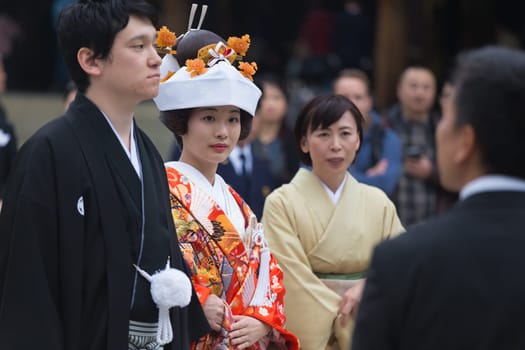 TOKYO, JAPAN - NOVEMBER 11: Wedding Ceremony in Tokyo, Japan on November 11, 2016. Photo of young groom and bride during japanese traditional wedding ceremony at Meiji-jingu shrine.