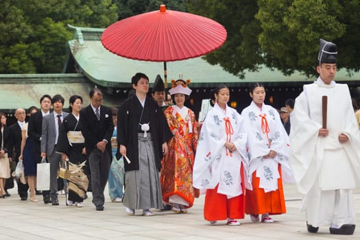 TOKYO, JAPAN - NOVEMBER 11: Wedding Ceremony in Tokyo, Japan on November 11, 2016. Photo of young groom and bride during japanese traditional wedding ceremony at Meiji-jingu shrine.