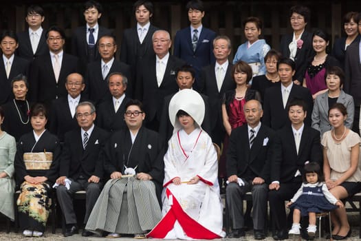TOKYO, JAPAN - NOVEMBER 11: Official group photography ceremony of groom and bride,family and guests attending traditional japanese wedding at Meiji-jingu shrine inTokyo, Japan on November 11, 2016.