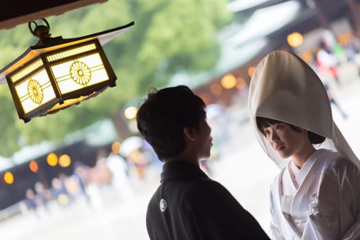 TOKYO, JAPAN - NOVEMBER 11: Wedding Ceremony in Tokyo, Japan on November 11, 2016. Photo of young groom and bride during japanese traditional wedding ceremony at Meiji-jingu shrine.