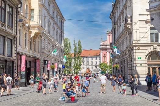Ljubljana, Slovenia - Aug 9, 2016: Urban street artist performing a soap bubble show for children in medieval city center of Slovenian capital Ljubljana in summer on 9th of August, 2016.