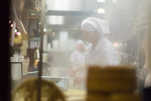 KYOTO, JAPAN - NOVEMBER 11: Ramen restaurant in Kyoto, Japan on November 11, 2016. Unidentified Japanese Ramen chefs prepare a bowl of traditional home made ramen noodle for customers.