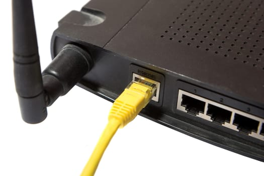 wireless router with yellow internet cable on white background