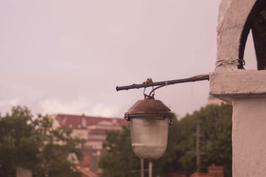 The old lantern hanging on the wall of the house background