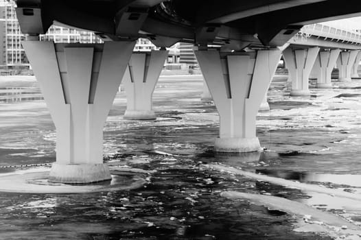 Bridge pillars in the cold water black and white background
