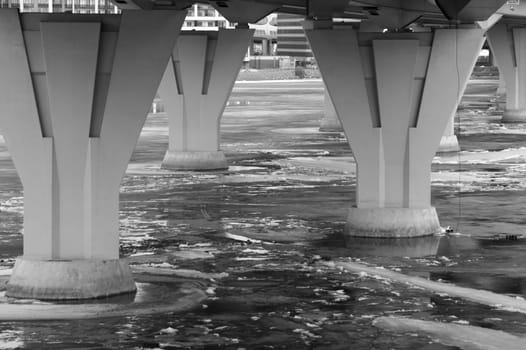 Bridge pillars in the cold water black and white background