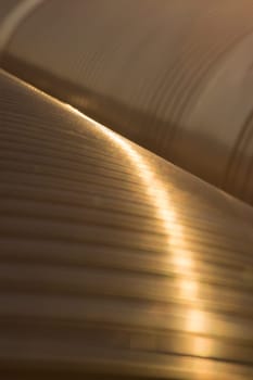 Golden metal pipes closeup background