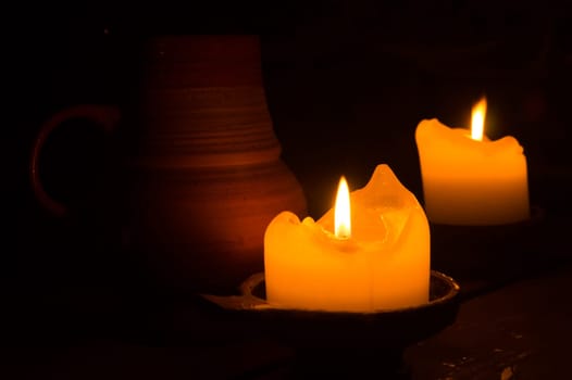 Burning candle in the dark