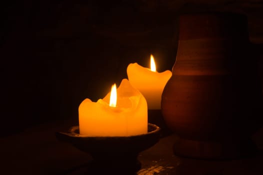 Burning candle in the dark